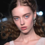 Silver floral earrings – Organic jewellery in sterling silver, with surreal leaves, chains, and a white pearl - on model – Livva