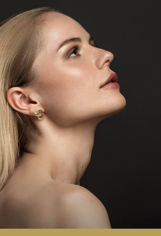 Organic earrings - Ear climbers in gold of organic leaf earrings crawling up and behind the ear on model – Livva - mobile