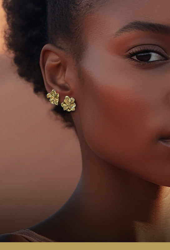 Organic jewellery - Two flower earring of leaves in gold - shown on model on same ear, wide - Livva Østerby