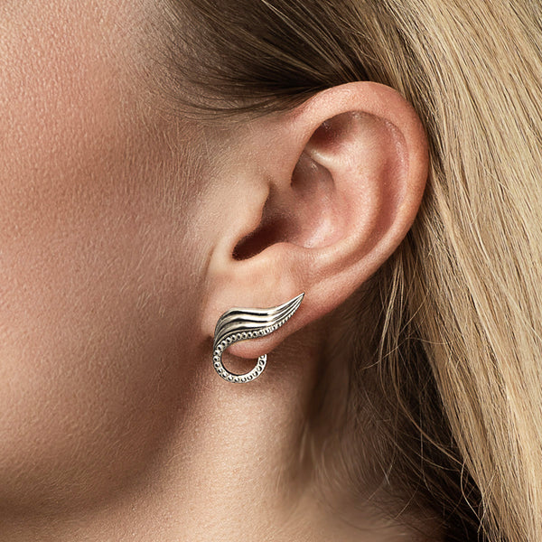 Ear climber - cool leaf earring in sterling silver, climbing up and behind the earlobe on model - Olivia O’Nello collection.