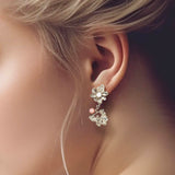 Flower drop earring – A unique floral design in sterling silver with 2 white & pink pearls on model – Alva Florali collection