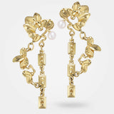 Gold floral earrings – Pair of organic jewellery design in gold, with surreal leaves, chains, and a white pearl - Livva