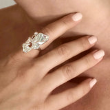 Organic ring in sterling silver with floating white pearl - Surreal statement ring covering a model’s finger - Alva Florali 