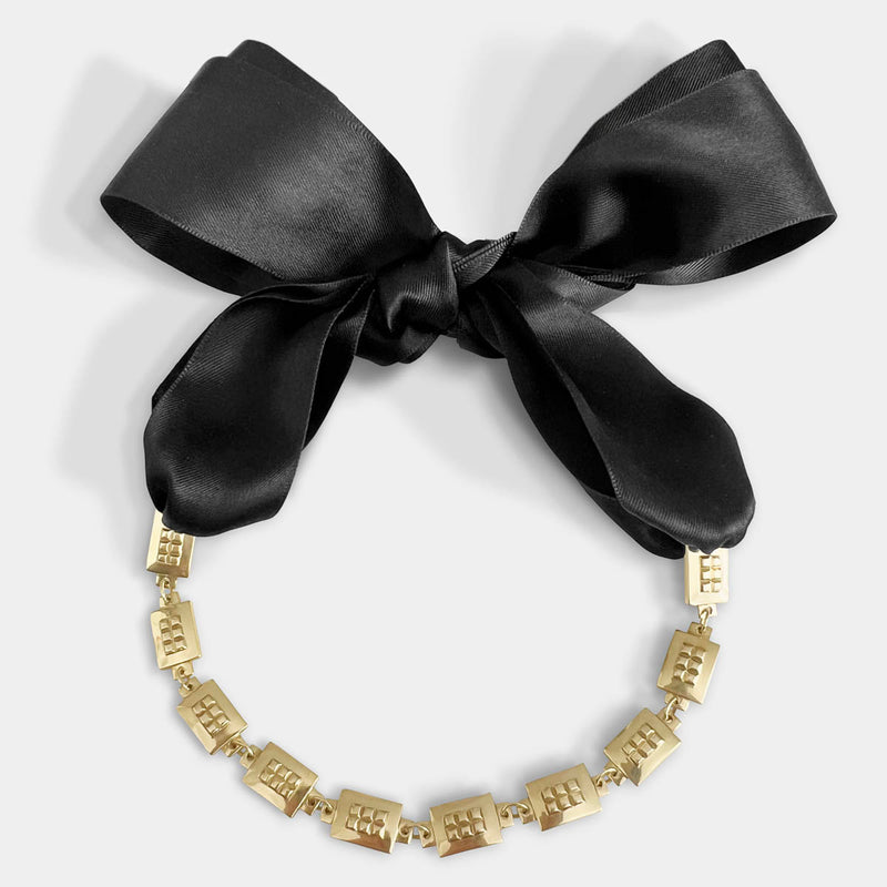 Square chain necklace – Chunky gold design with tiny studs & elegant black satin ribbon closure – Livva Østerby.