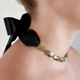 Square chain necklace – Chunky gold design - Tiny studs & elegant black satin ribbon closure on model from side – Livva Østerby.