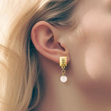 Square earrings – Square gold design with tiny studs & elegant snow quartz gemstone dangle on model – Livva Østerby.