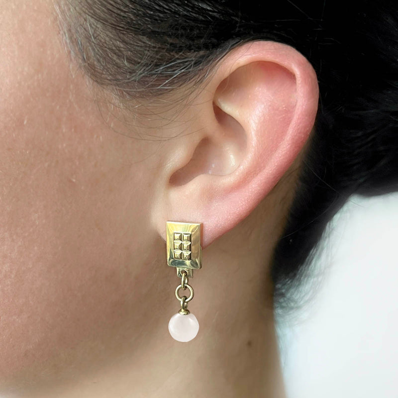 Square earrings – Square gold design with tiny studs & elegant snow quartz gemstone dangle on casual model – Livva Østerby.