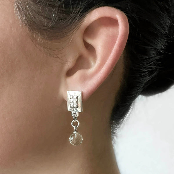 Silver square earrings – Square design with tiny studs & elegant clear quartz gemstone dangle on model – Livva Østerby.