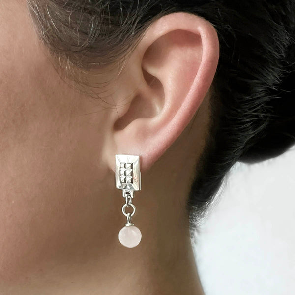 Square earrings – Square design with tiny studs & elegant snow quartz gemstone dangle on model – Livva Østerby.