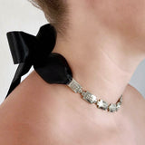 Square link chain necklace – Chunky silver with tiny studs & black satin ribbon closure on model from side – Livva Østerby.