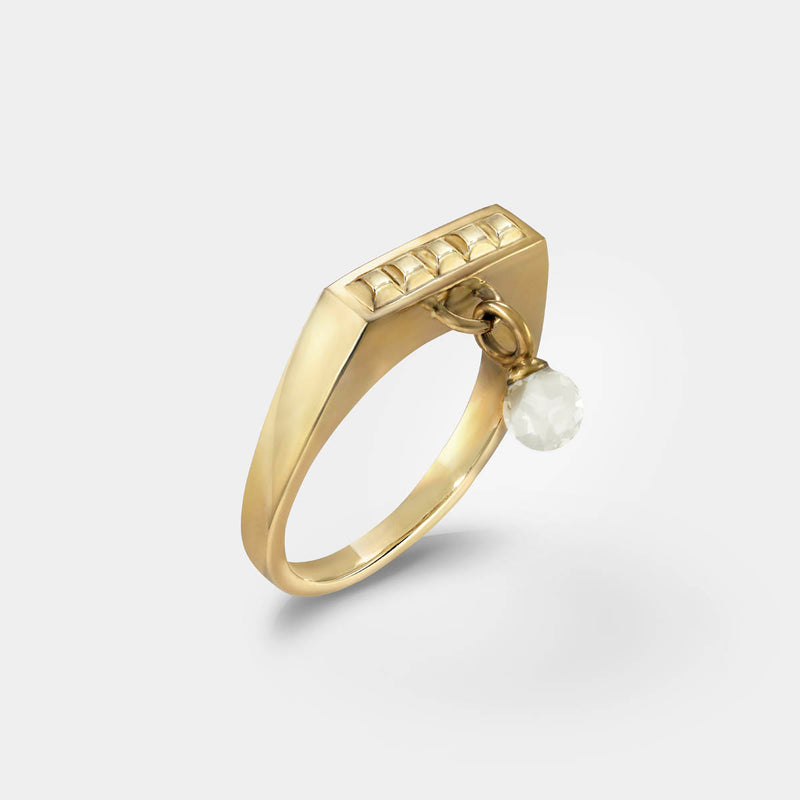 Square gold ring – Sleek square design with tiny studs and a clear quartz dangle charm – Livva Østerby.