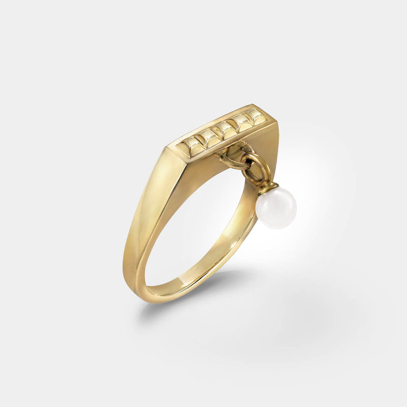 Square ring in gold – Sleek square design with tiny studs & a snow quartz dangle charm – Livva Østerby.