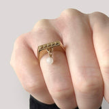 Square ring in gold – Sleek square design with tiny studs & a snow quartz dangle charm on hand from above – Livva Østerby.