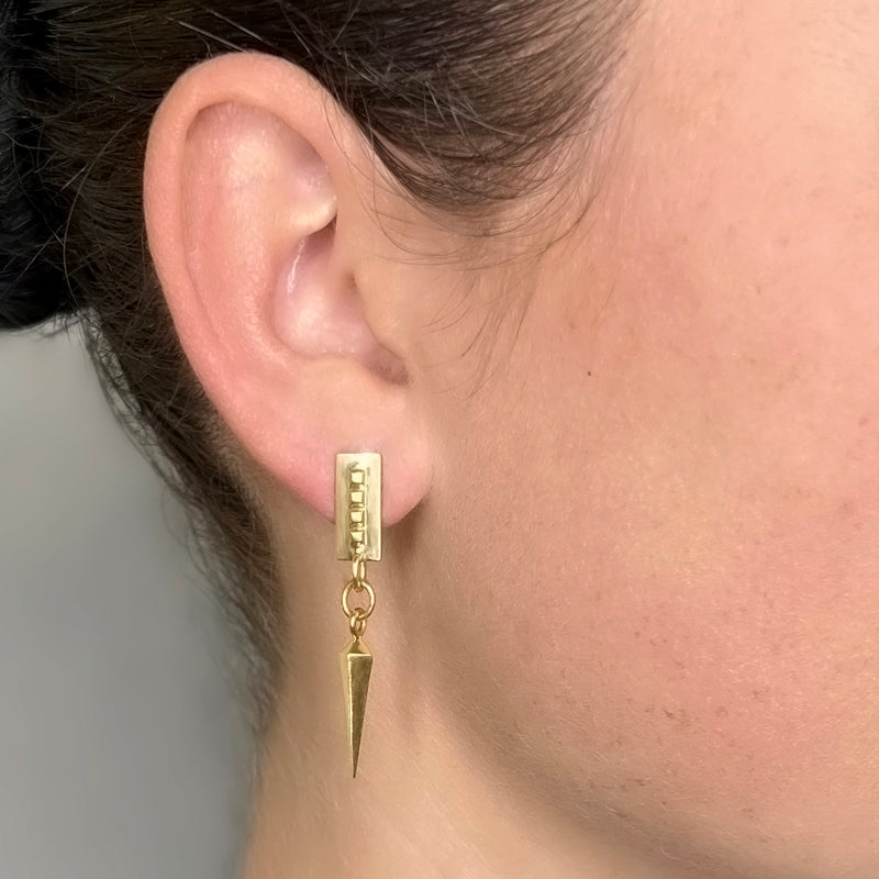 Spike earrings gold – A sleek square design with tiny studs and a dangling spike on casual model – Livva Østerby.