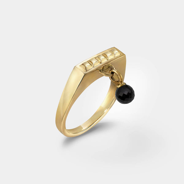 Square ring gold – A sleek square design with tiny studs and a black spinel dangle charm – Livva Østerby.