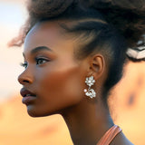 Statement flower earring in sterling silver 925 with a white- and a pink pearl shown on model – Alva Florali collection