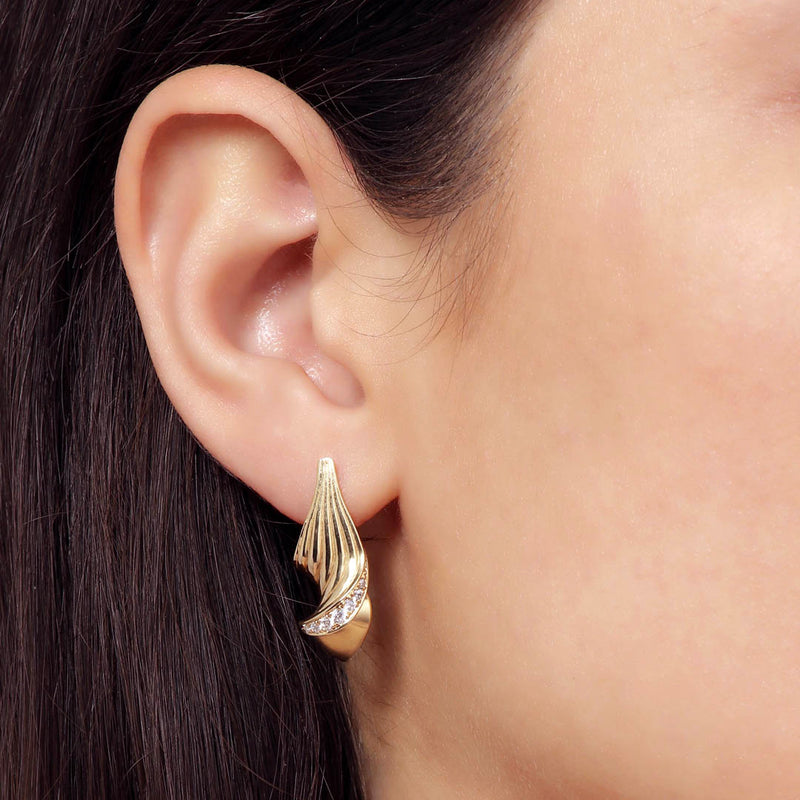 Twist diamond earrings - innovative sculptural twist of classic luxury earrings in 18k gold - Grace York collection on model.
