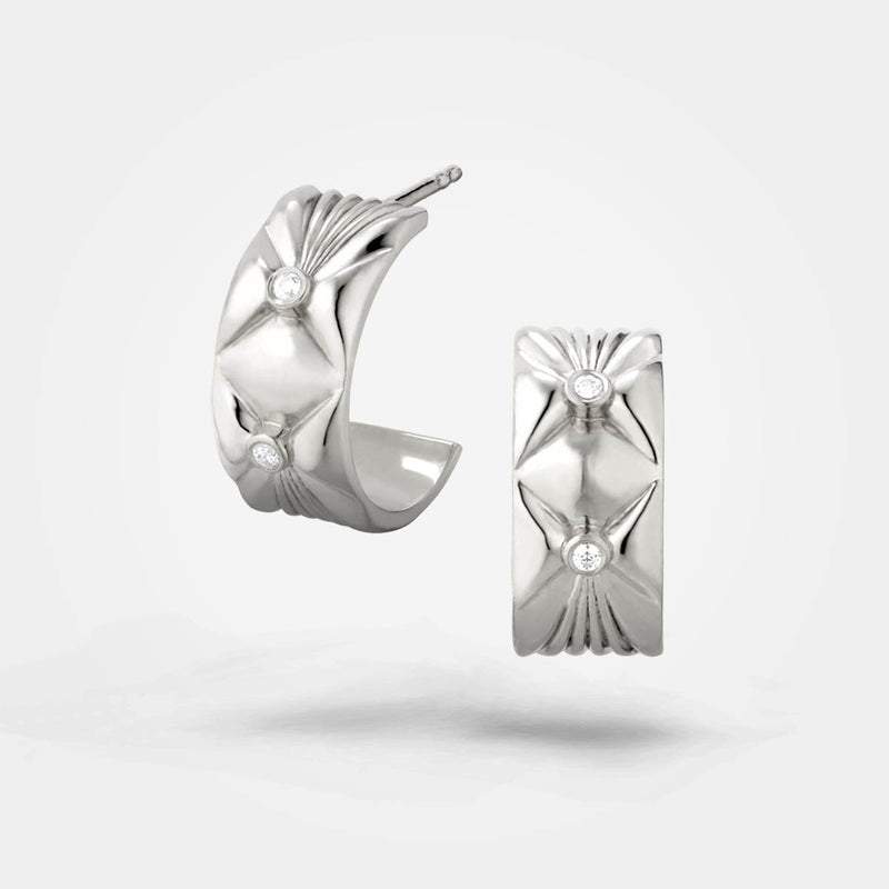 Wide silver earrings with 2 white diamonds. A chunky jewellery design with organic lush surface - Sofia Chester collection.